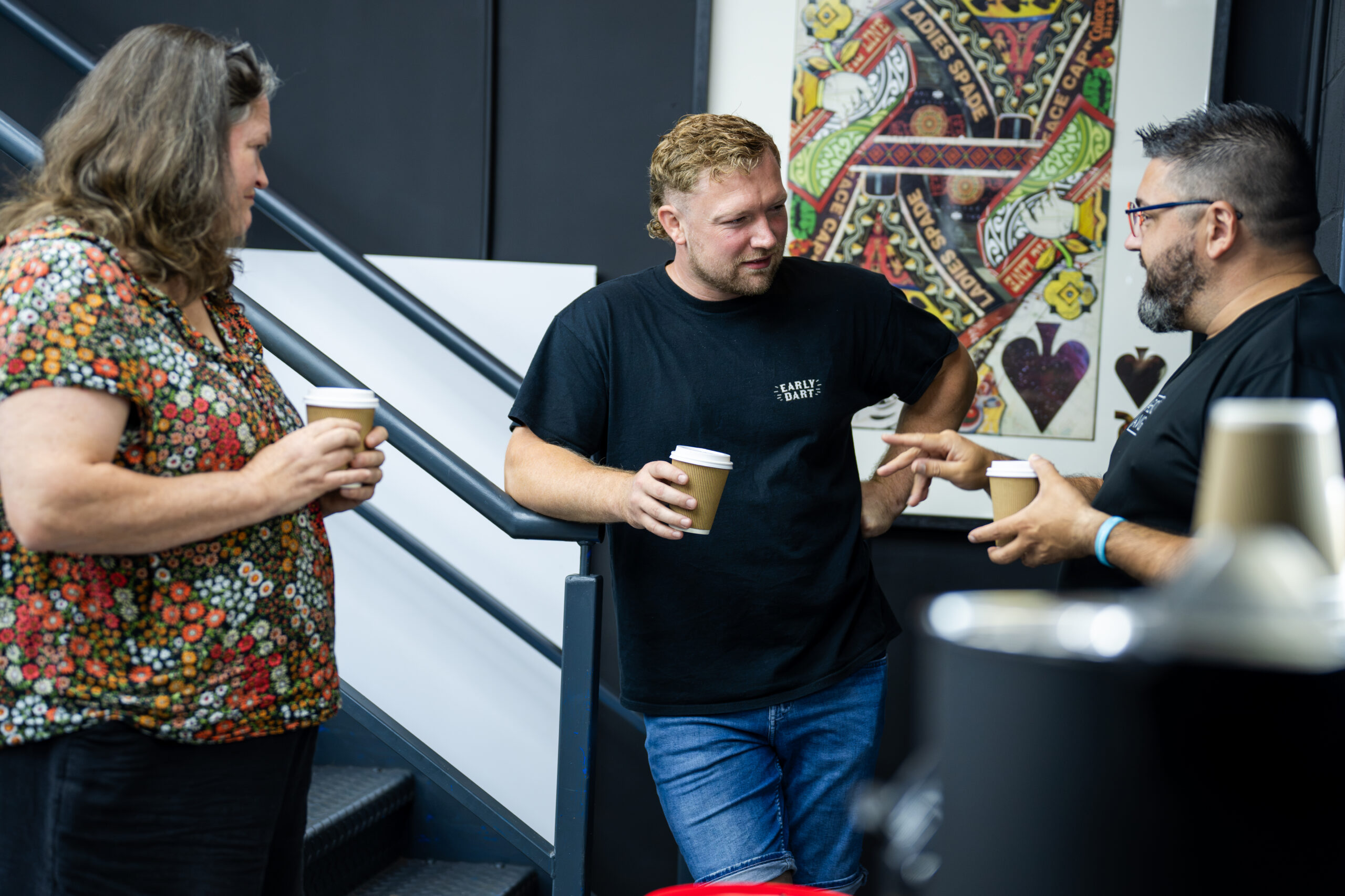 Bud chatting with attendees over a coffee